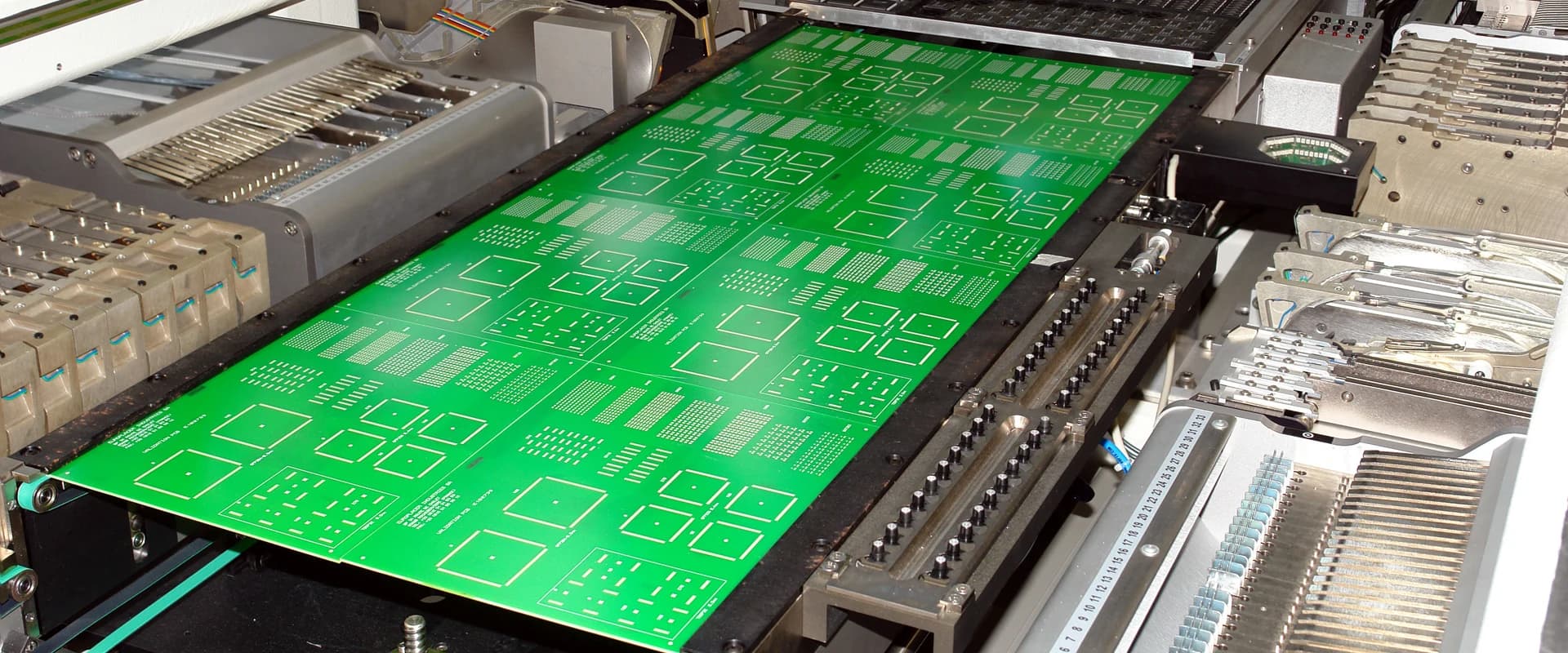 A printed circuit board panel moving through the production line